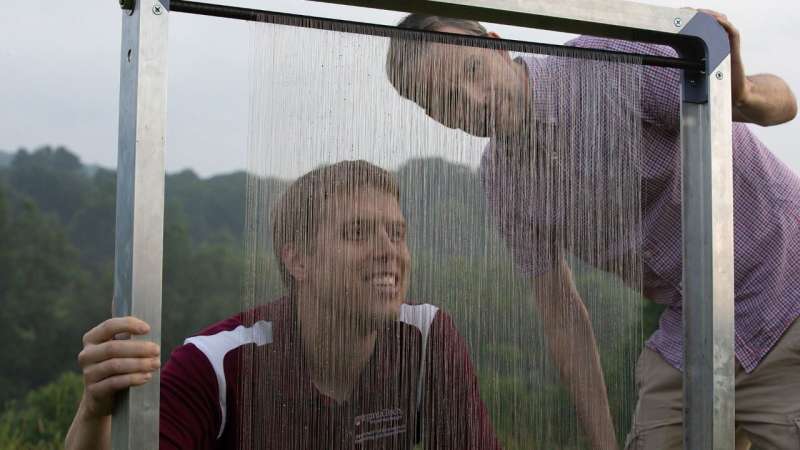 (From left) Jonathan Boreyko and Brook Kennedy in 2018 with the original fog harp. Credit: Peter Means for Virginia Tech. Virginia Tech fog harp gets an upgrade