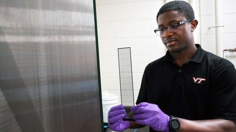 Jimmy Kaindu inspects a new collecting prototype beside the original fog harp. Credit: Alex Parrish for Virginia Tech. Virginia Tech fog harp gets an upgrade